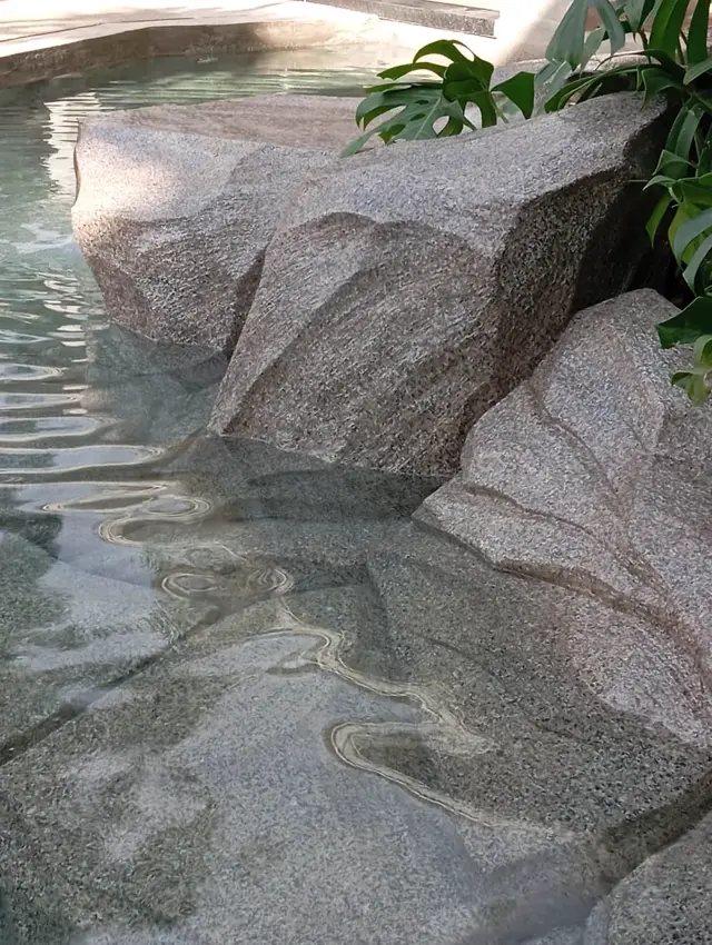 Conjunto de pedras esculpidas na entrada da piscina